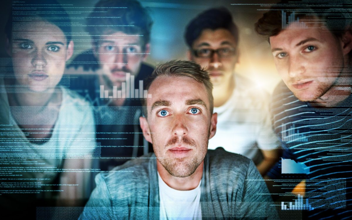 Portrait of a group of young people using a computer with a virtual screen during a late night at work